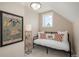 Comfortable bedroom features a daybed with decorative pillows and a whimsical art piece at 616 W 1St Ave, Denver, CO 80223