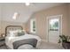 Bright bedroom featuring a skylight and access to a balcony at 616 W 1St Ave, Denver, CO 80223