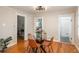Bright dining room with hardwood floors, glass table, and views into kitchen and bathroom at 616 W 1St Ave, Denver, CO 80223