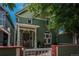 Charming two-story home with a cozy front porch and lush green surroundings at 616 W 1St Ave, Denver, CO 80223
