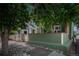 Charming home with a green exterior, mature trees, and a white picket fence at 616 W 1St Ave, Denver, CO 80223