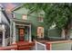 Charming home with inviting front porch, well-maintained lawn, and classic architectural details at 616 W 1St Ave, Denver, CO 80223