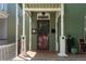 Charming front porch features a green-painted façade and white columns, with the house number visible at 616 W 1St Ave, Denver, CO 80223