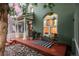 Inviting front porch with seating, striking arched window, and a charming, colorful exterior at 616 W 1St Ave, Denver, CO 80223