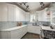 Modern kitchen features all-white cabinets, subway tile backsplash and stainless steel appliances at 616 W 1St Ave, Denver, CO 80223