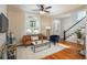 Living room featuring hardwood floors, ceiling fan and large arched window for natural lighting at 616 W 1St Ave, Denver, CO 80223