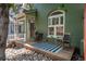 Inviting front porch with wooden deck, seating, and decorative rocks at 616 W 1St Ave, Denver, CO 80223