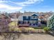 Two-story home with a wooden deck, fenced yard, patio, and landscaping at 730 Pope Dr, Erie, CO 80516