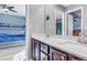 Well-lit bathroom featuring double sinks and modern fixtures, located next to a blue-themed bedroom with bunkbeds at 730 Pope Dr, Erie, CO 80516