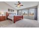 Bedroom featuring a large window offering plenty of natural light, ceiling fan, and neutral colors at 730 Pope Dr, Erie, CO 80516