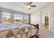 Bright bedroom features a ceiling fan and three large windows offering lots of natural light and neighborhood views at 730 Pope Dr, Erie, CO 80516