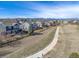 View of a two-story home with a fenced yard backing onto a walking path with mountain views at 730 Pope Dr, Erie, CO 80516