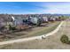 View of a two-story home with a fenced yard backing onto a walking path with mountain views at 730 Pope Dr, Erie, CO 80516