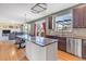 Bright kitchen featuring granite countertops, stainless steel appliances, and seamless flow into the living area at 730 Pope Dr, Erie, CO 80516