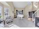 Bright living room with high ceilings, lots of natural light, a white piano and decorative chair at 730 Pope Dr, Erie, CO 80516