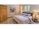 Comfortable bedroom with a queen-sized bed, neutral decor, and natural light at 100 Apache Rd, Evergreen, CO 80439