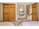 Bedroom view through doorway, features wooden doors, carpet and neutral walls at 100 Apache Rd, Evergreen, CO 80439