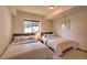 Comfortable bedroom with two beds, featuring natural light and inviting decor at 100 Apache Rd, Evergreen, CO 80439