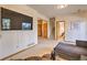 Lower-level living room area with wood-look flooring, flatscreen TV and access to stairs at 100 Apache Rd, Evergreen, CO 80439