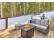 Cozy deck with a fire pit and comfortable seating for outdoor relaxation at 100 Apache Rd, Evergreen, CO 80439