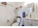 Bright half-bathroom featuring a white vanity, decorative shelves and modern fixtures at 9530 E Florida Ave # 2001, Denver, CO 80247