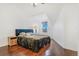Bedroom with sloped ceiling, dark wood floors, modern furniture and bright window at 9530 E Florida Ave # 2001, Denver, CO 80247