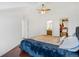 Bright vaulted bedroom with ceiling fan, ensuite bath, closet, and dark wood floors at 9530 E Florida Ave # 2001, Denver, CO 80247