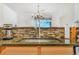 Kitchen with stylish backsplash and stainless steel sink at 9530 E Florida Ave # 2001, Denver, CO 80247