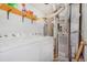 Functional laundry room with washer, dryer, storage shelves, and utilities at 9530 E Florida Ave # 2001, Denver, CO 80247