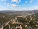 Beautiful aerial view of a mountain community surrounded by evergreen forests and distant peaks at 72 Overlook Ct, Idaho Springs, CO 80452
