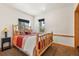 Bright bedroom featuring a log-frame bed and sunny windows at 72 Overlook Ct, Idaho Springs, CO 80452