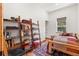 Charming bedroom featuring wooden shelves, accent rug, and a window to the outdoors at 72 Overlook Ct, Idaho Springs, CO 80452