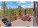 Spacious deck with mountain views, outdoor seating, BBQ grill, and hot tub at 72 Overlook Ct, Idaho Springs, CO 80452