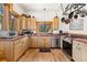 Cozy kitchen with wood cabinets, stainless steel appliances, and a view of the scenic landscape at 72 Overlook Ct, Idaho Springs, CO 80452