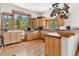 Bright kitchen featuring wood cabinets, hardwood floors, tile countertops, and stainless steel appliances at 72 Overlook Ct, Idaho Springs, CO 80452