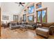 Bright living room with vaulted ceilings, large windows, hardwood floors, and comfortable seating area at 72 Overlook Ct, Idaho Springs, CO 80452