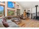 Bright living room featuring a stone fireplace, high ceilings, and expansive windows showcasing scenic views at 72 Overlook Ct, Idaho Springs, CO 80452