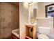 Unfinished bathroom features a shower stall, toilet and vanity sink with mirror at 12879 E Oregon Dr, Aurora, CO 80012