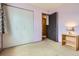 Bedroom featuring carpeted floors, closet, and an open door to the hallway at 12879 E Oregon Dr, Aurora, CO 80012