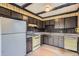 Retro kitchen featuring vintage appliances and wood cabinets at 12879 E Oregon Dr, Aurora, CO 80012