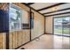 Living room featuring vintage decor with dark wooden beams and large sliding glass door leading to the backyard at 12879 E Oregon Dr, Aurora, CO 80012