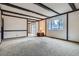 Bright living room with beamed ceilings, carpet, and a large window overlooking the yard at 12879 E Oregon Dr, Aurora, CO 80012