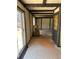 Sunroom featuring beamed ceilings, sliding glass doors, and neutral flooring at 12879 E Oregon Dr, Aurora, CO 80012