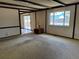 Spacious living room with beamed ceilings, a large window, and carpeted floors at 12879 E Oregon Dr, Aurora, CO 80012