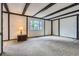 Living room with dark wood beam ceiling and a large window offering natural light at 12879 E Oregon Dr, Aurora, CO 80012