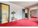 Spacious main bedroom with red carpeting, red and white themed wall, and sliding mirror closet at 12879 E Oregon Dr, Aurora, CO 80012