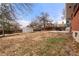 Large backyard featuring a shed, a patio, and a wood fence, providing ample space at 8140 Pennsylvania Way, Denver, CO 80229