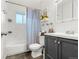 Cozy bathroom with a tub and shower combo, neutral paint, and ample storage with modern vanity at 8140 Pennsylvania Way, Denver, CO 80229