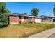 Lovely brick home featuring an attached garage, solar panels, and a cozy front porch in a desirable neighborhood at 8140 Pennsylvania Way, Denver, CO 80229