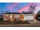 Charming single-story brick home featuring a two-car garage, solar panels, and cozy front porch, and nice landscaping at 8140 Pennsylvania Way, Denver, CO 80229